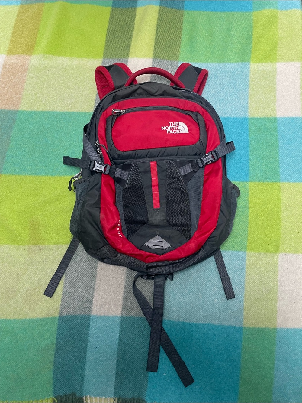 The North Face Recon backpack in charcoal gray and bright red